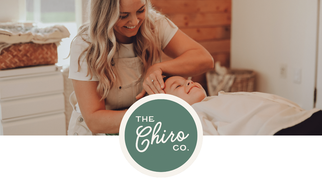 Chiropractor Dr. Jenna Carter providing care to a child at The Chiro Co. chiropractic studio, emphasizing holistic family wellness.